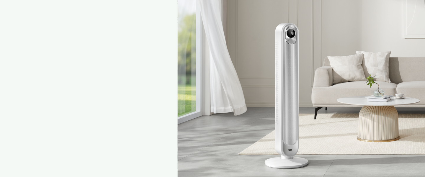 Tall white tower fan in a modern living room setting with a couch and coffee table.